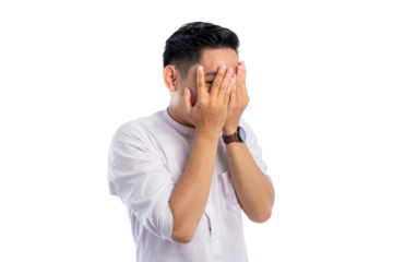 Handsome Asian Muslim man peeking at the camera through his fingers, embarrassment covering his face isolated on transparent background