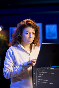 Programmer walking in apartment designing and developing software applications using laptop. IT expert standing in living room, implementing and maintaining company systems