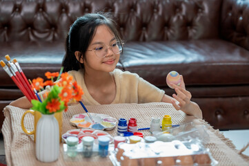 A girl paint eggs for easter celebration at home,traditional season