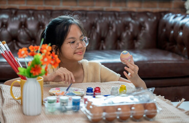 A girl paint eggs for easter celebration at home,traditional season