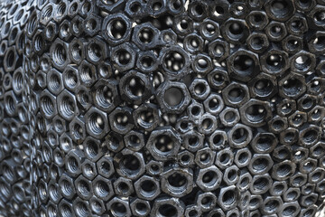 Metal creative background of welded bolts.
