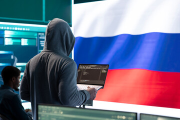 Propagandist person in a Russian cybersecurity center with the national flag works on installing...