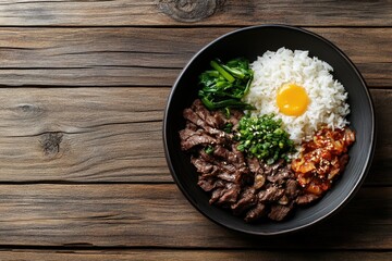 Delicious Korean beef bowl with rice, kimchi, egg yolk, and greens.