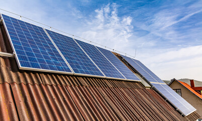 Fototapeta premium Photovoltaic panels on a roof of family house, solar panels.
