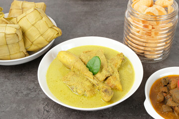 Opor Ayam, served with ketupat and sambal goreng ati. Popular during Eid al Fitr. Indonesian traditional food
