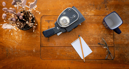 Vintage 8mm film camera on a wooden table - brighter