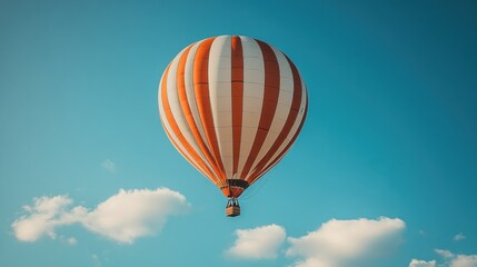 Naklejka premium Colorful hot air balloon soaring high above fluffy clouds in a clear blue sky