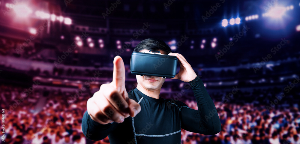 Poster man pointing while standing at arena and playing game by using augmented reality technology. asian g