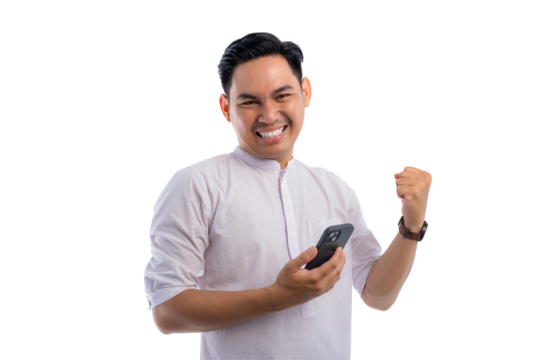 Happy Asian Muslim man holding mobile phone, gesturing yes with clenched fist, getting good news isolated on transparent background