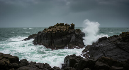 Dark volcanic rocks surrounded by crashing ocean waves with white foam spray. Powerful seascape ideal for nature conservation awareness, environmental protection campaigns