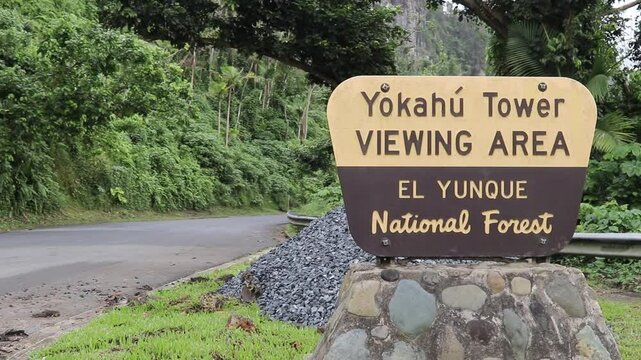 Sign of the Yokahu Tower viewing area in El Yunque National Forest, Puerto Rico, on a cloudy day