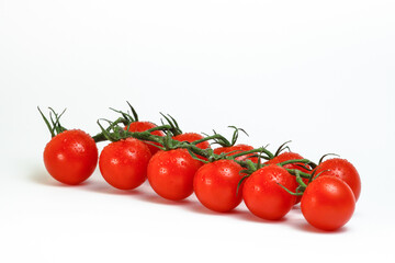 Cherry tomatoes on a branch on a white background