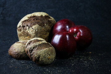 dark bread with red apples on a dark background