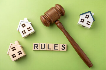 Real Estate Law Concept With Gavel Houses And Rules Blocks On Green