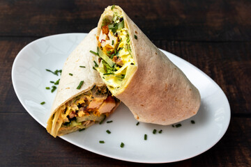 Wrap filled with spicy chicken, lettuce, and herbs.