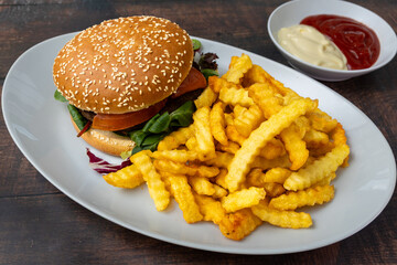 Classic hamburger with lettuce, tomato, and fries.