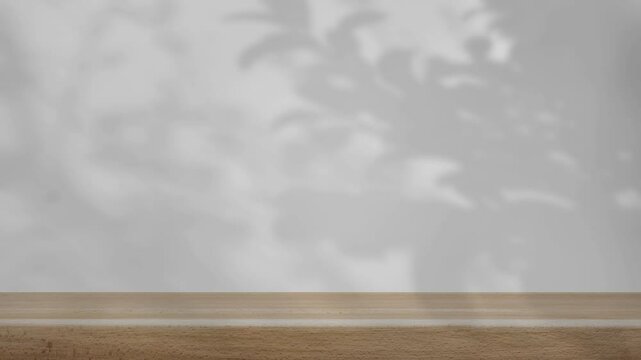 shadow of the trees gently swaying in the breeze, on a white background with a wooden table.