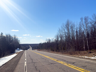 A highway crossing a forest in Wisconsin during early spring