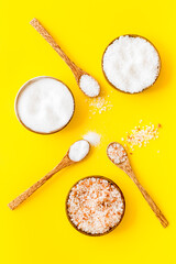 White and pink salt - coarse and finely - in wooden bowls, top view. Salt for spa, salt baths or cooking