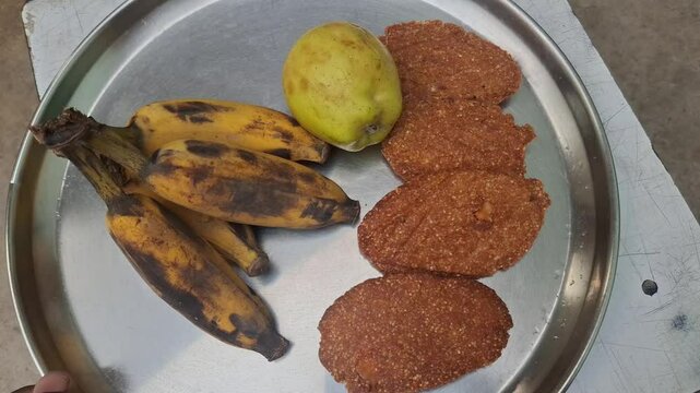 a plat of guava, banana and Thekua. It's commonly offered as prasad during the Chhath Puja festival in Bihar and other regions of India