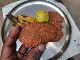 a plat of guava, banana and Thekua. It's commonly offered as prasad during the Chhath Puja festival in Bihar and other regions of India