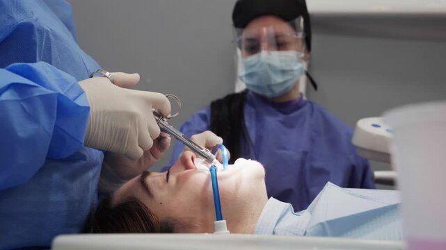 Dentist performing dental procedure on patient