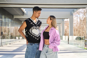 Young couple confronting each other on city walkway