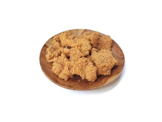 Crispy fried chicken skin on wooden plate isolated on white background 