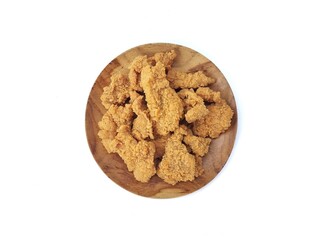 Crispy fried chicken skin on wooden plate isolated on white background, Top view 