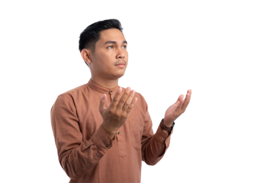 Religious Asian Muslim man praying with raised hands isolated on transparent background. Ramadan and Eid Fitr celebration concept