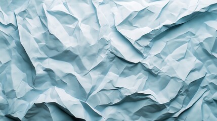 Obraz premium Crumpled light blue paper texture with shadows and highlights