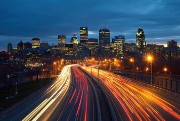 Obraz premium Wide-angle dusk cityscape with light trails from vehicles on a highway in the foreground, illuminated skyscrapers under a gradient sunset sky blending orange and indigo hues