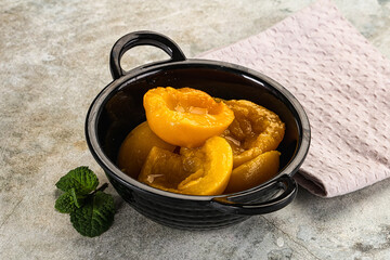 Canned marinated peach in syrop