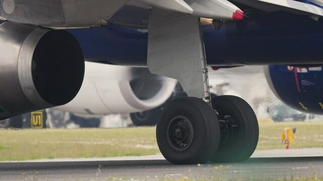 Airplane wheels taxiing on runway before takeoff