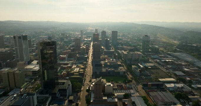 Aerial perspective of Pretoria city center, skyline and main traffic route in South African metropolis. Great for urban and infrastructure footage. Scenic Aerial 4K establishing panning shot