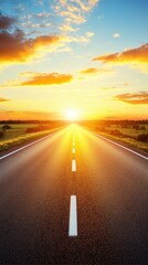 Endless asphalt road stretching towards the horizon under a vibrant golden sunset with dramatic clouds and green fields creating a sense of freedom and adventure