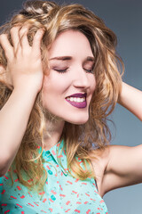 Fototapeta premium Portrait of Young Caucasian Sensual Expressive Girl With Beautiful Long Curly Hairs