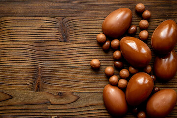 Chocolate background - various chocolate eggs and candies, top view