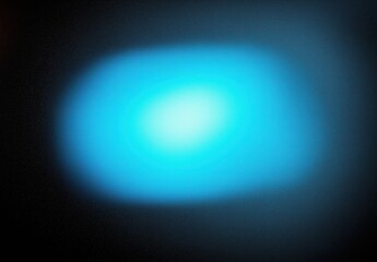 Soft Blurry Blue Light Emitting from a Dark Background Creating a Tranquil Atmosphere