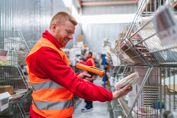 Smiling warehouse worker scanning products with barcode scanner, managing inventory and logistics in distribution center