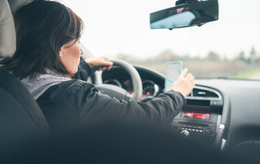 Woman Prepares For A Long Car Trip By Setting The Map Route On The Gps Navigator On Smartphone