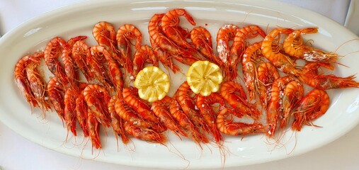 Boiled shrimps dish in a restaurant. Shrimp dish on a plate close-up. Shrimp menu restaurant.