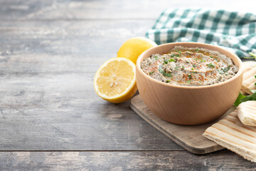 Traditional baba ganoush in bowl on wooden table. Copy space