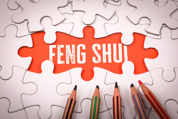 Feng Shui. White puzzle pieces and colored pencils