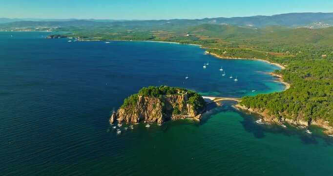 Aerial view of Fort Bregancon sunset aerial view from the mediterranean sea. A yacht is anchored near the fortress