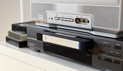 An old TV with a VCR on the table.90s.