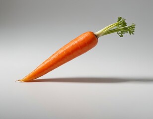 Fresh, vibrant carrot with green tops, suspended against a minimalist background.