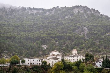 Obraz premium traditional Spanish architecture, nestled into the Anadlusian hills, on a rare rainy day in southern Spain