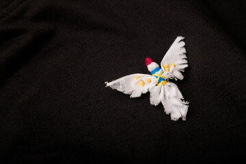 White dove, symbol of peace with Ukrainian national flag colored embroidery stitches. Textile...