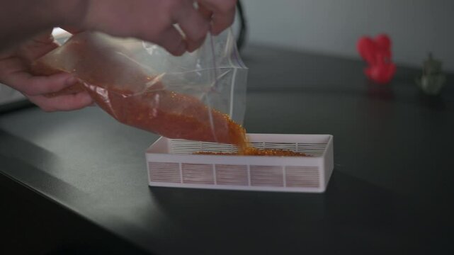 Pouring silica gel to a special plastic container.